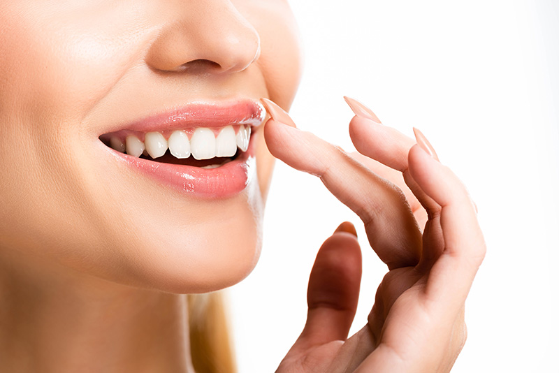 partial view of woman with white teeth isolated on white